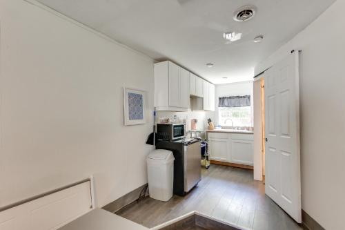 a kitchen with white cabinets and a stove top oven at 2 Mi to Long Beach Waterfront! Convenient Studio in Long Beach