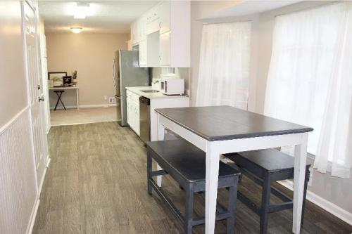 a small kitchen with a table and a counter top at The Stockbridge Hideaway in Stockbridge