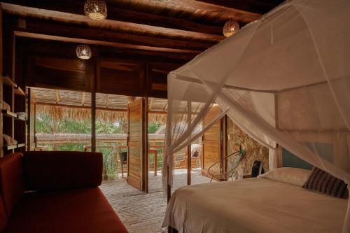 a bedroom with a bed in a room with a window at Casa del Mar AC Rustic design Pool Paceful in Santa María Tonameca