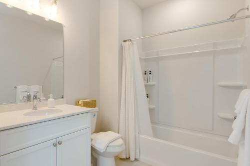 a white bathroom with a toilet and a shower at Modern Gem Near Historic Annapolis and Naval Academy in Annapolis