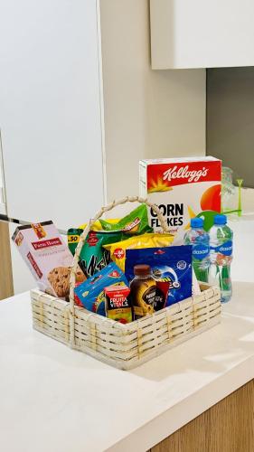 a basket of food and other snacks on a counter at Gold Crest Mall & Residency Premium Apartments With Al-Fatah Store & Shopping Mall in Lahore