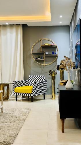 a living room with a couch and a table at Gold Crest Mall & Residency Premium Apartments With Al-Fatah Store & Shopping Mall in Lahore