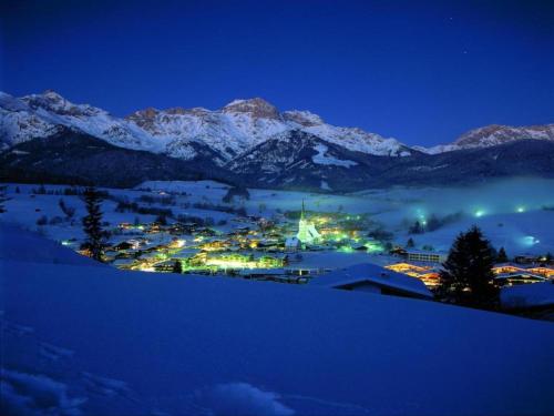 a town in the snow at night with mountains at Paarsch in Schinking
