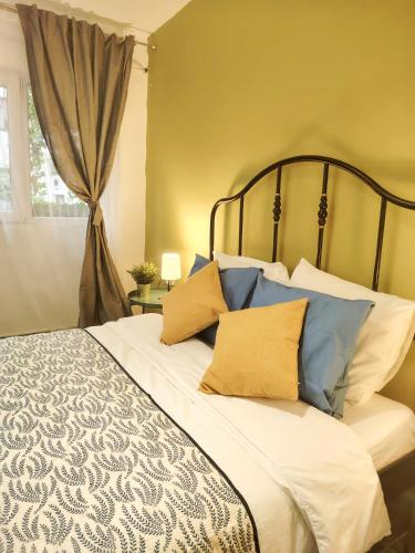 a bedroom with a bed with blue and white pillows at Pura Vida Downtown Tiny houses in Bucharest