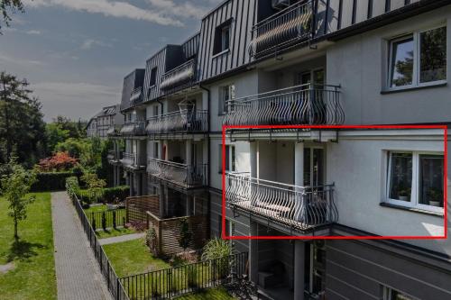 an apartment building with its balconies and a window at BATOREGO FLATS No 13 Pszczyna - Walk to Castle - Apartment with Parking, Balcony, Elevator, Fast WiFi in Pszczyna