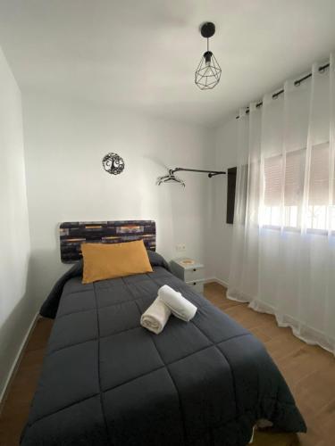 a bedroom with a large bed with two towels on it at Casa Rural Maria in Pinos Genil