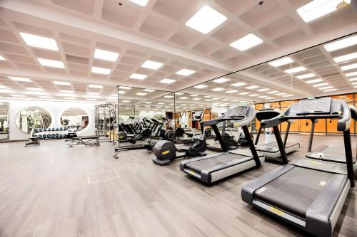 a gym with treadmills and elliptical machines at Green Hillside Apartment in Phu Quoc