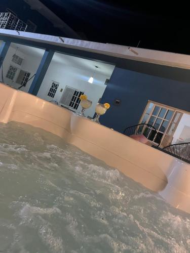 a pool of water in front of a house at Casa Punta Perula in Pérula