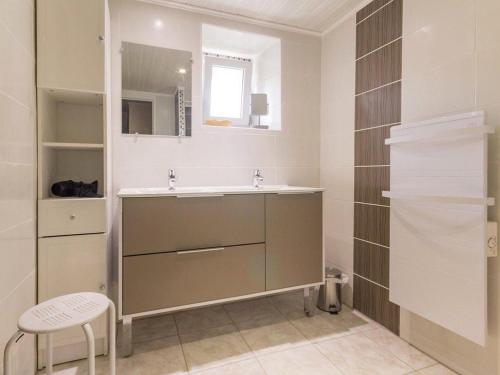a bathroom with a sink and a mirror at Gîte familial avec jardin clos, à proximité de Guérande et des plages, dans le Parc de Brière - FR-1-306-1070 in Crossac