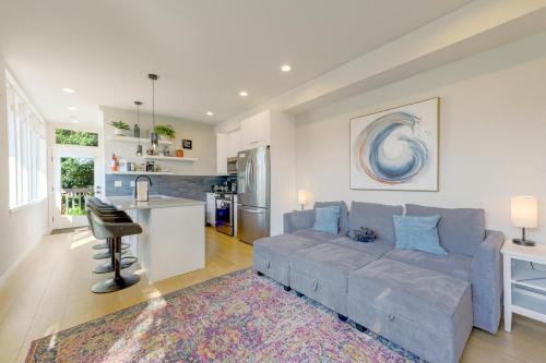 a living room with a couch and a kitchen at Perch - Wallingford Comfort in Seattle