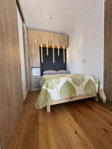 a bedroom with a large bed and a wooden floor at Casa Colon Reforma in Mexico City