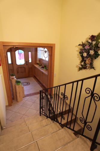 a hallway with a staircase with a wreath on the wall at Haus Helga in Kappl