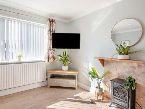 a living room with a fireplace and a flat screen tv at Sweetpea - Uk48838 in Ingoldmells