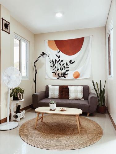 a living room with a couch and a coffee table at SafeHouse Elyu Transient in Bangcusay
