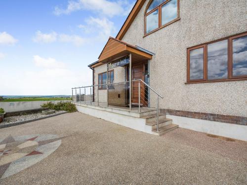 a house with a staircase on the side of it at Sir A Wel in Llanerchymedd