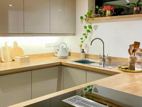 a kitchen with a sink and a counter top at The Bungalow in Rushton Spencer