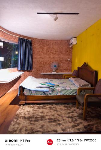 a bedroom with a bed and a brick wall at Long Homestay Mỹ Hạnh - Hotels in Ðức Hòa