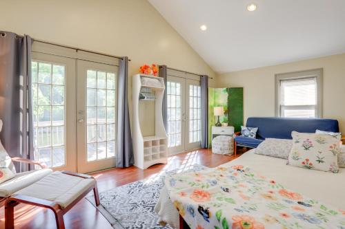 a bedroom with a bed and a couch and windows at Franklin Home with Deck, Creek Views Walk to Shops in Franklin
