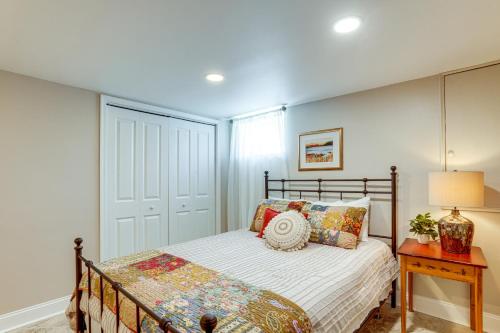 a bedroom with a bed and a table with a lamp at Shenandoah Valley Riverside Retreat Near Wineries in Grottoes