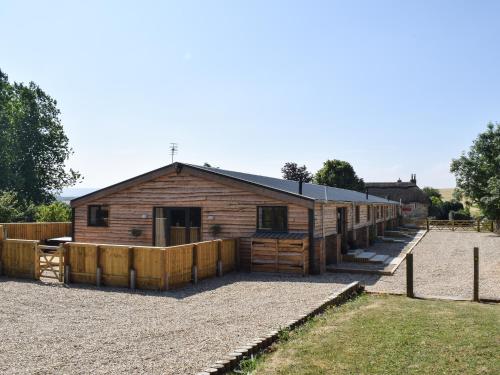 a wooden barn with a fence in front of it at Madeline Angevine - Ukc3208 in Newbridge