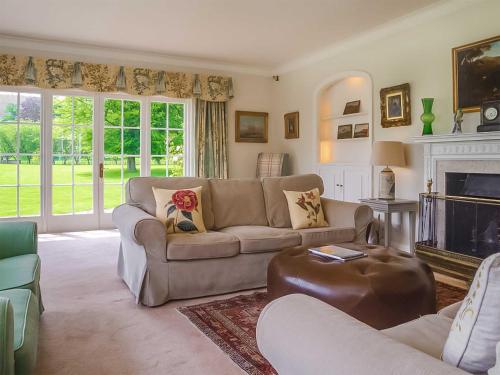 a living room with a couch and a fireplace at Glanusk Lodge - Uk46654 in Crickhowell