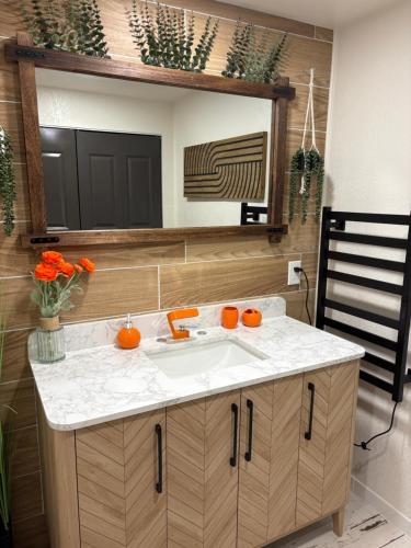a bathroom with a sink and a mirror at The Cozy nest in Englewood