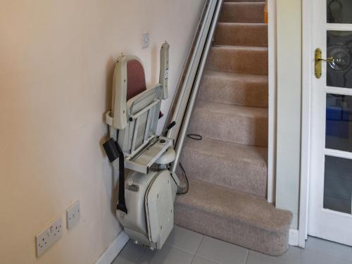 an empty stair lift in a room with stairs at Swallowdale in Flordon