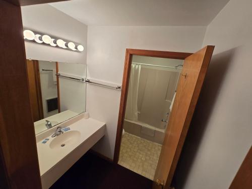 a bathroom with a sink and a shower at Lake View Motel in Cooperstown