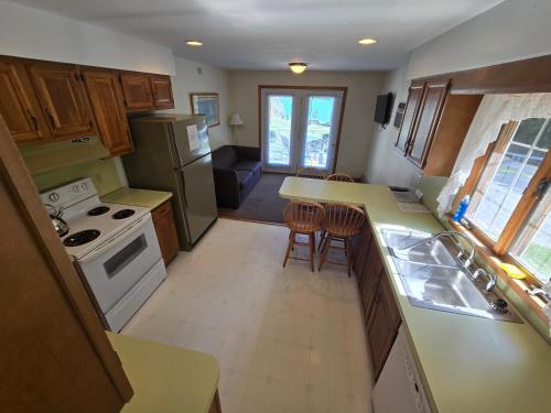 a kitchen with a sink and a stove top oven at Lake View Motel in Cooperstown