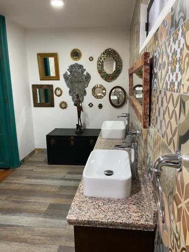 a bathroom with a sink and two mirrors on the wall at Paraíso Real in Buga