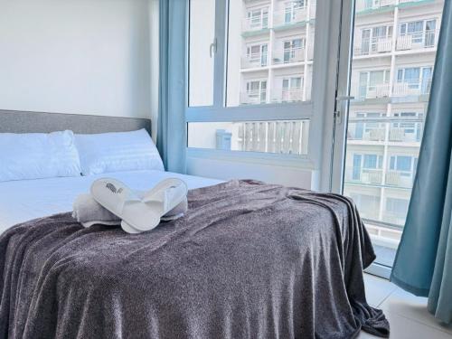 a bed with a pair of white hearts on it at Condo Unit at Cool Suites SMDC Wind Tagaytay in Tagaytay