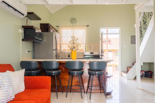 a kitchen with a counter and stools in a room at Musgrave AnneX- comfy 1 bedroom apartments in Kingston
