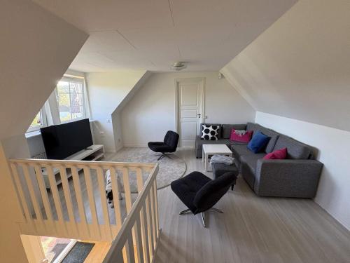 an overhead view of a living room with a couch and chairs at 5 star holiday home in Löderup in Kåseberga