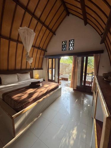 a bedroom with a large bed in a room at Rising Sun Bungalows in Gili Meno