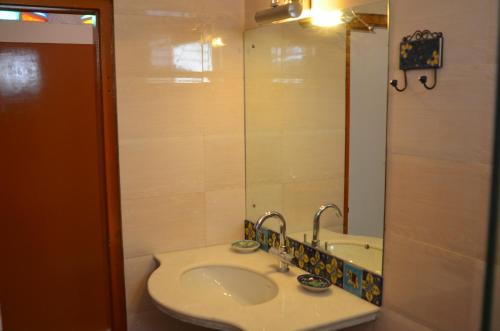 a bathroom with a sink and a mirror at Rampura Kothi in Jaipur