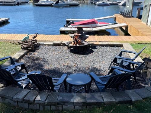 a fire pit with chairs and a fire hydrant at 2 Rivers Inn The Thousand Islands - LUXURY WATERFRONT WALKOUT in Gananoque