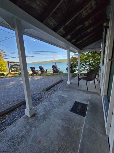 a porch of a house with a view of the ocean at Lake View Motel in Cooperstown