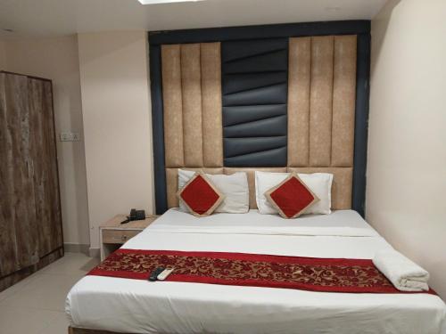 a bedroom with a large bed with red pillows at Hote The HTP Near IGI Airport New Delhi in Jāmb