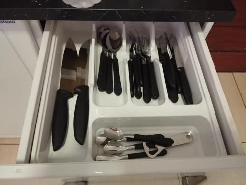 a drawer full of utensils in a refrigerator at Casa em Sete Lagoas - até 12 pessoas - Preço Justo in Sete Lagoas