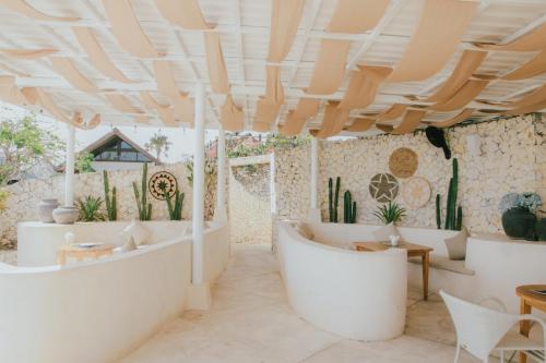una sala de estar con muebles blancos y cactus en Karma Kandara, en Uluwatu