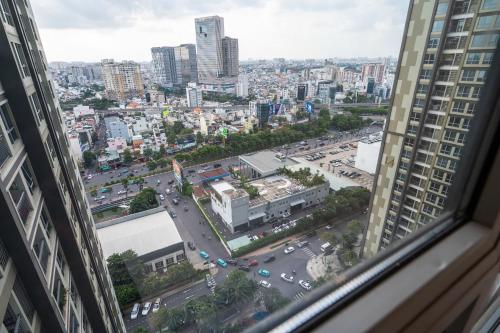 a view of a city from a window of a building at The Sun Avenue Apartment Moonlight in Ho Chi Minh City