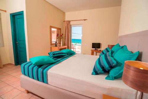 a bedroom with a bed with a view of the ocean at Oreia in Palaiochóra