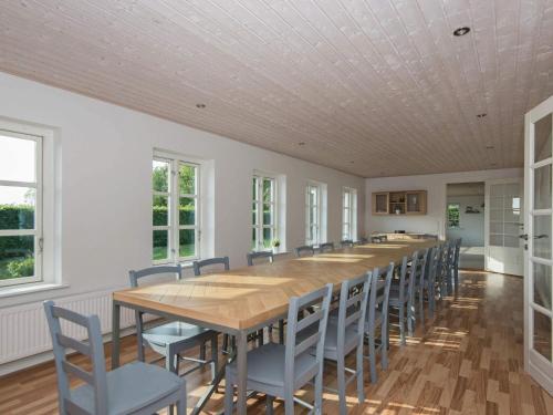 a large dining room with a long table and chairs at 20 person holiday home in Ørsted in Ørsted