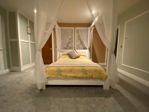 a bedroom with a bed with a canopy at Gelilah House in Loughbrickland