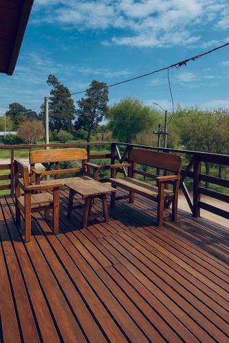 two benches and a picnic table on a deck at Relax in New Andalucía- Tu refugio costero con pileta in Miramar