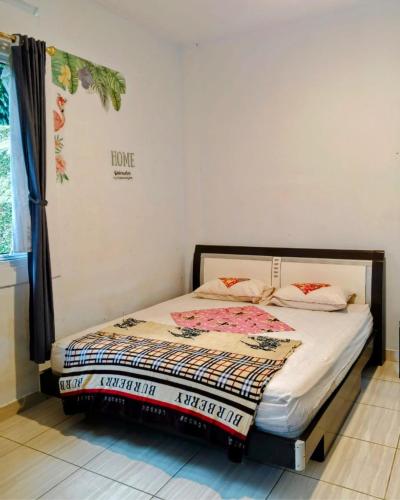 a bedroom with a bed in a room at Alvaro Resort Bukit Angin in Ciguntur