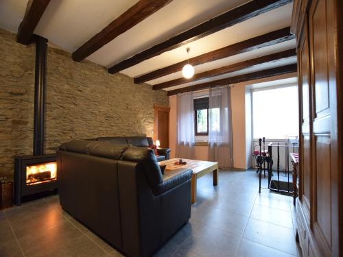 a living room with a couch and a fireplace at Pretty cottage with billart and 2 bathrooms in Marfontaine