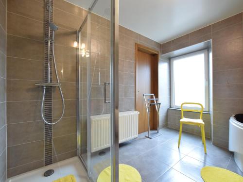 a bathroom with a shower with a glass door at Pretty cottage with billart and 2 bathrooms in Marfontaine