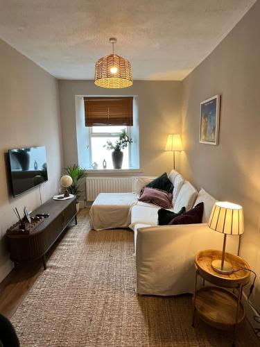 a living room with a bed and a couch at 3 Bedroom, 5 Bed Home in the Heart of Galway in Galway