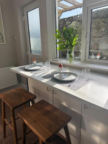 a kitchen with a table with glasses and a vase at 3 Bedroom, 5 Bed Home in the Heart of Galway in Galway